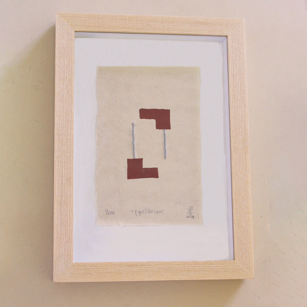 The Adorned framed and hand stitched block printed artwork called Equilibrium Terracotta
