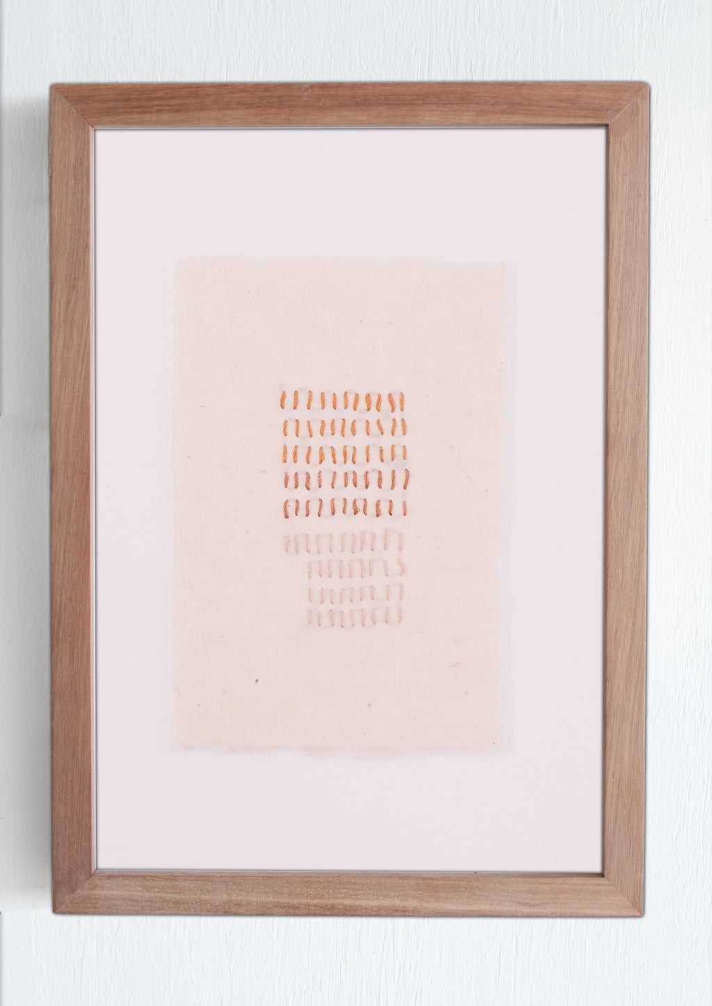 Framed artwork with a gradient background and text on a white wall