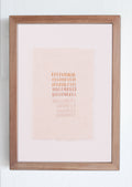 Framed artwork with a gradient background and text on a white wall