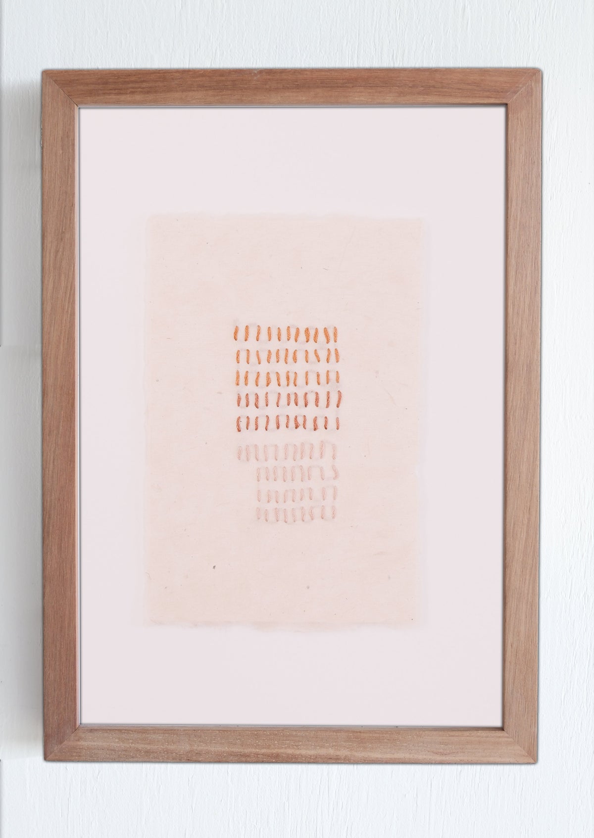 Framed artwork with a gradient background and text on a white wall