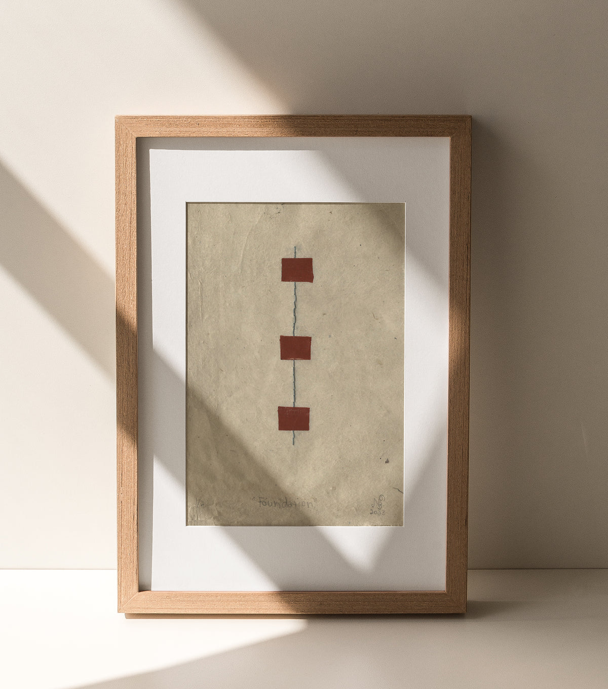 The Adorned framed and hand stitched block printed artwork called The Foundation with shadows across frame