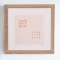 Framed artwork with text on a white wall